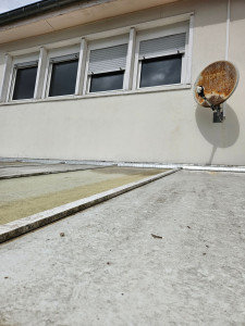 Photo de galerie - Installation d'un bandeau de goudron entre le mur et le toit de la véranda pour réaliser une nouvelle étanchéité. 