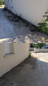 Photo de galerie - Débroussaillage et nettoyage complet d'une copropriété : suppression des mauvaises herbes, dégagement des bordures, nettoyage des abords des murs et des clôtures.