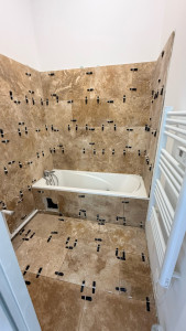 Photo de galerie - Nous avons retiré l’ancien carrelage de la salle de bain, installé une baignoire et posé le nouveau carrelage.
