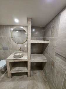 Photo de galerie - Rénovation complète de salle de bain de A à Z : création des cloisons hydrofuges, isolation, plomberie, électricité, carrelage et mobilier sur mesure.