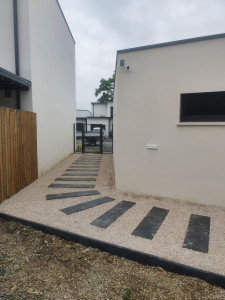 Photo de galerie - Aménagement d'allé de gravier sur alvéoles 
et pas d'ardoise 
 