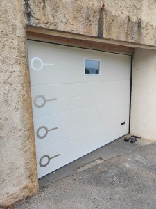 Photo de galerie - Installation porte de garage sectionnelle motorisée avec pose de vitrage.