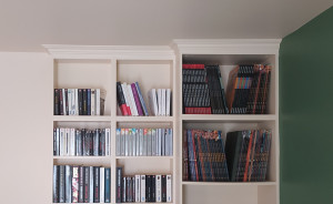 Photo de galerie - Mise en place des moulures pour combler les quelques centimètres entre le haut de la bibliothèque et le plafond. Mise en peinture et pose d'un vernis. Tous les trous et les jonctions entre les meubles ont été comblés pour un effet 