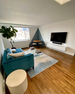 Photo de galerie - Création d'un angle décoratif géométrique en peinture bleu-gris (y compris les plinthes) sur fond blanc pour structurer un coin repas avec des lignes parfaitement nettes.
suite 