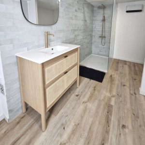 Photo de galerie - Rénovation complète de salle de bain moderne avec douche à l’italienne, carrelage mural effet pierre naturelle.