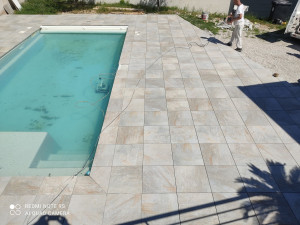 Photo de galerie - Création d'une dalle autour de la piscine puis pose de carrelage 
