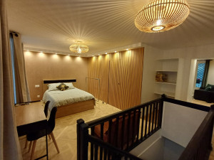 Photo de galerie - Réalisation d'une chambre complète 
sol parquets Versailles  / murs habillage bois phonique et enduits ton chocolat  / installation d'une porte invisible  / électricité complète  / aménagement complète  etc.