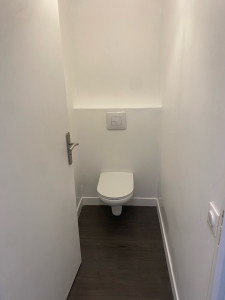 Photo de galerie - Peinture des murs, pose des plinthes et pose de stratifié au sol dans les toilettes.