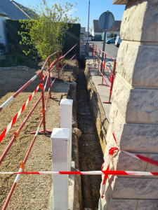 Photo de galerie - Terrassement d'une tranchée pour accueillir la fondation du futur mur de clôture.