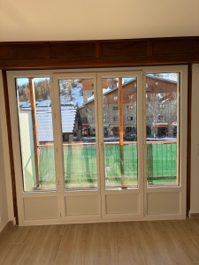 Photo de galerie - Pose fenêtre double vitrage avec 2 fixe et ouvrant à la française bi color blanc intérieur et bois extérieur en pvc