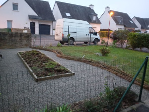 Photo de galerie - Réalisation d'un parterre en gravier autour des carrés potagers, bordure en saule tressé, plantation d'une haie de petits fruitiers, et de vivasses.