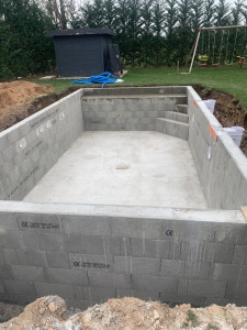 Photo de galerie - Réalisation de la structure d’une piscine en blocs à bancher avec dalle béton et escaliers intégrés. Travail précis pour assurer solidité, étanchéité et durabilité de l’ouvrage.