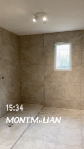 Photo de galerie - Réalisation d’une salle de bain en carrelage 60 × 120 cm, avec une pose précise et des joints réguliers pour un rendu moderne, élégant et soigné.
