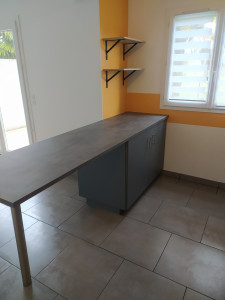 Photo de galerie - Montage et installation d'un plan de travail avec caissons pour avoir un coin repas et plus de rangement dans une cuisine ouverte. Installation de deux étagères murales par la même occasion.