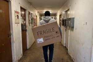 Photo de galerie - Transport de carton fragile dans couloir immeuble aide manutention sans véhicule 