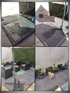 Photo de galerie - Création d’une terrasse en dalles béton sur lit de sable, avec un massif décoratif en pétales d’ardoise, réalisée après un décaissement et un nivellement pour offrir un espace extérieur propre et immédiatement prêt à profiter