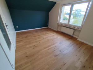 Photo de galerie - Pose de parquet en bois massif avec ses plinthes blanches en périphérie 