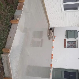 Photo de galerie - Terrasse beton sur mesure avec un pan coupé et une réservation de 80cm x 80 cm pour la plantation d'un arbuste (dans la terrasse)
