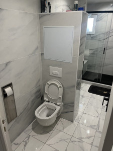 Photo de galerie - Réalisation d'une salle de bain complète avec pose de carrelage installation de WC douche.