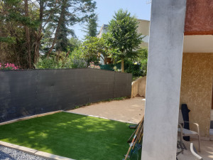 Photo de galerie - Aménagement de jardin avec terrain de pétanque et mise en place de synthétique 