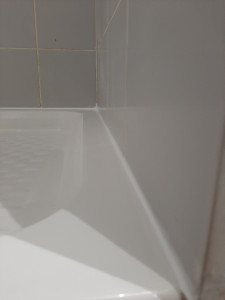 Photo de galerie - Réalisation d'un joint d'étanchéité suite à une fuite d'eau sur une salle de bain chez le client.