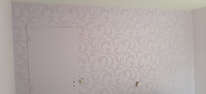 Photo de galerie - Pose d'un papier à peindre sur un mur d'une chambre avec 2 couches de velours