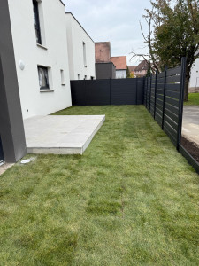 Photo de galerie - Réalisation d’une terrasse avec des dalles sur plots, pose de clôture occultant, pose de gazon rouleau 