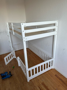Photo de galerie - Montage d'un lit avec matelas en hauteur et petit parc en bas avec porte qui se verrouille.