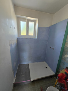 Photo de galerie - Rénovation salle de bain pose du receveur, plage de sortie de douche, pose d'une cloison sèche pour passage d'arrivée d'eau et protection des murs à l'eau.