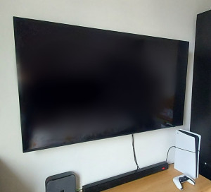 Photo de galerie - Installation téléviseur sur mur en briques rouges.