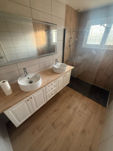 Photo de galerie - Transformation d’une salle de bain avec douche à l’italienne, meuble vasque design et finitions contemporaines pour un résultat à la fois esthétique et confortable.