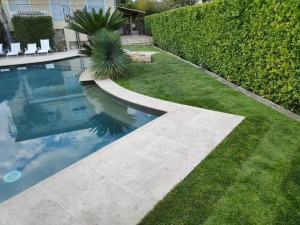 Photo de galerie - Entretien de jardin : pelouse et bordures soignées aux abords d’une piscine. Réalisation Nice Garden.