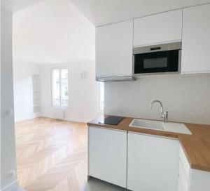 Photo de galerie - Création d'une cuisine ultra fonctionnelle ouverte sur la pièce principale.
